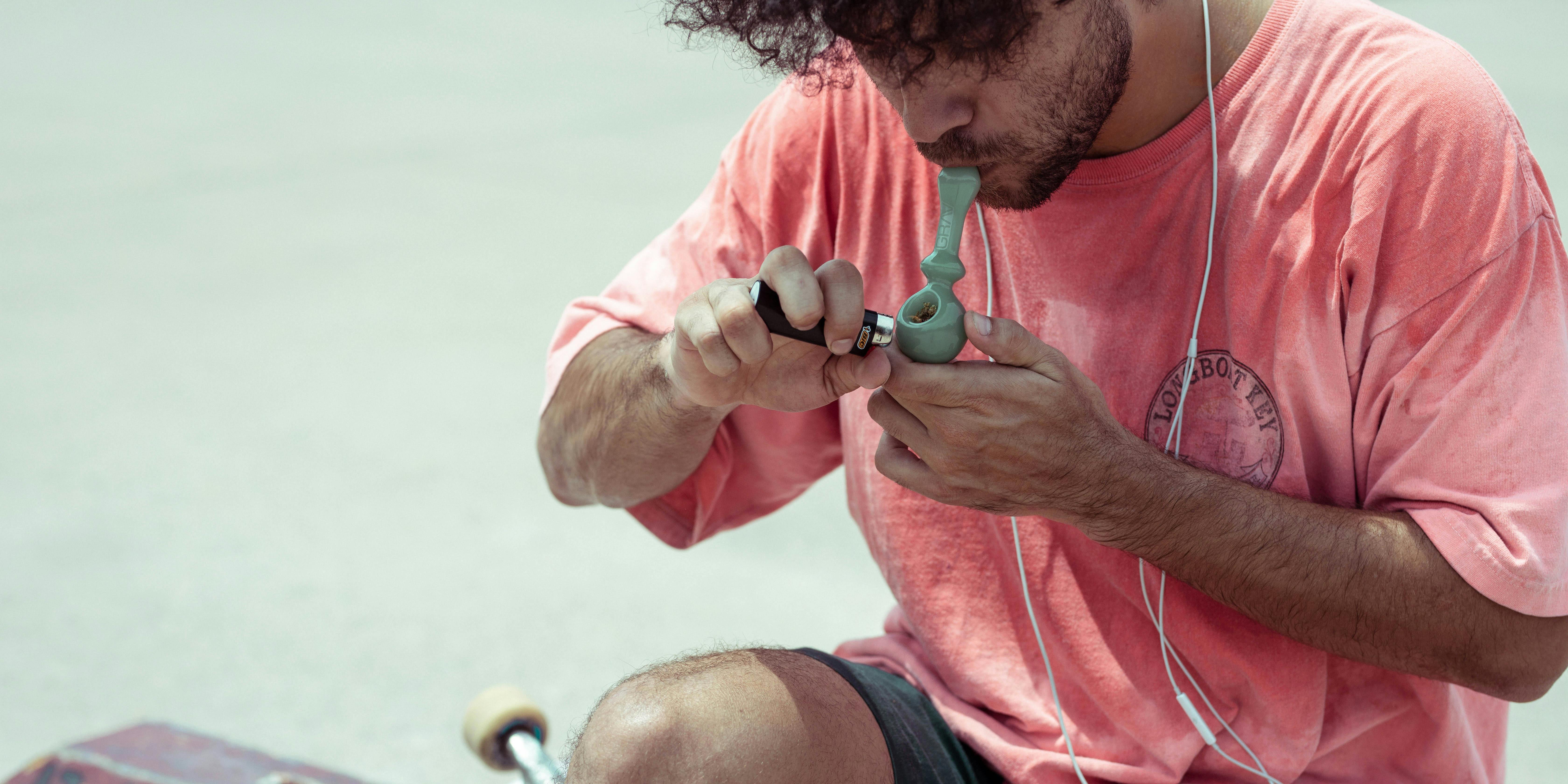 A man smokes out of a pipe. Cannabis in Canada, now that it's legal, is about to give visitors a whole new perspective on a country they thought they knew.