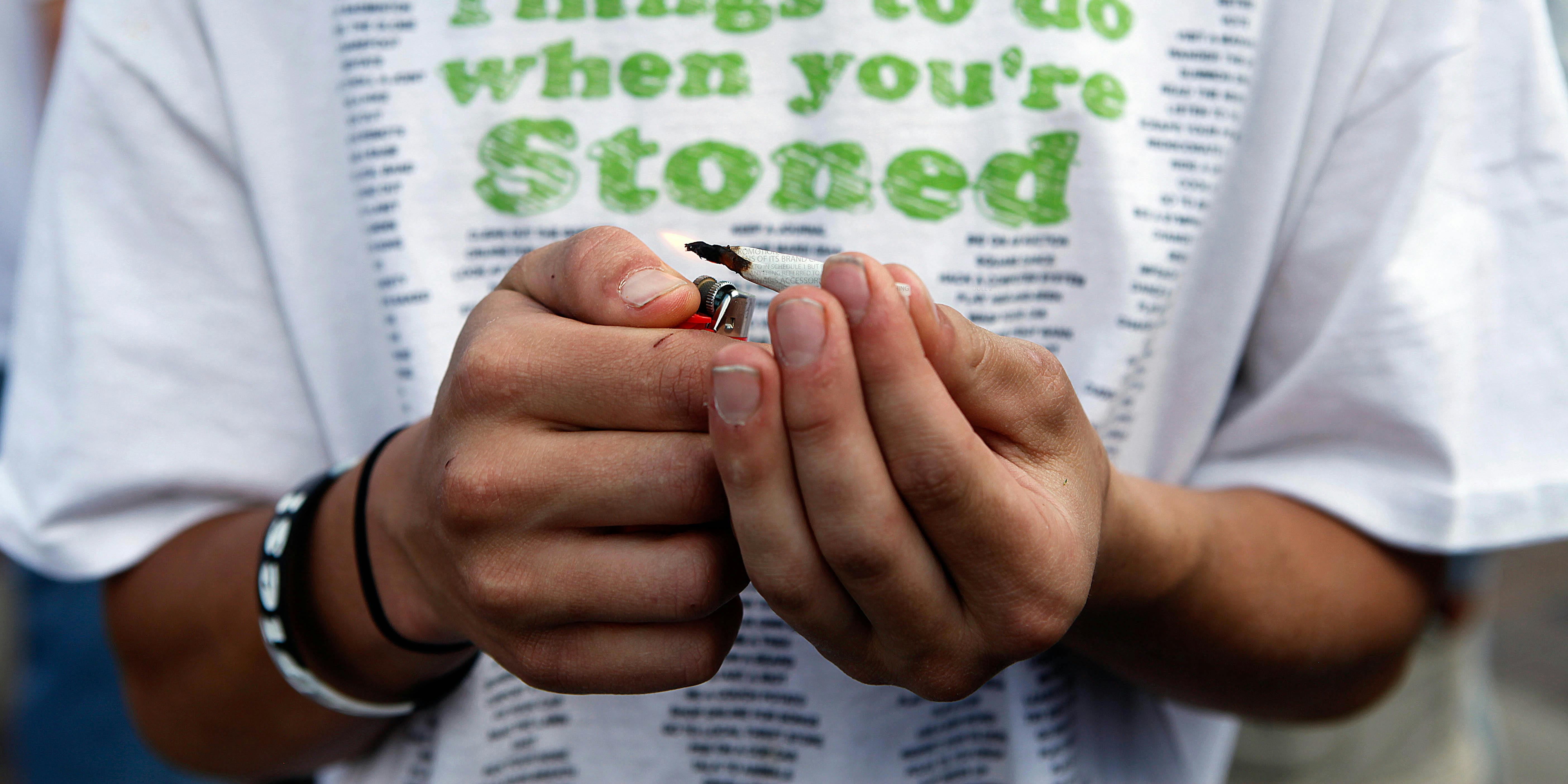 Someone lights a joint. In Canada, the cannabis-startup accelerator, Leaf Forward, just created the best rolling papers to celebrate legalization.