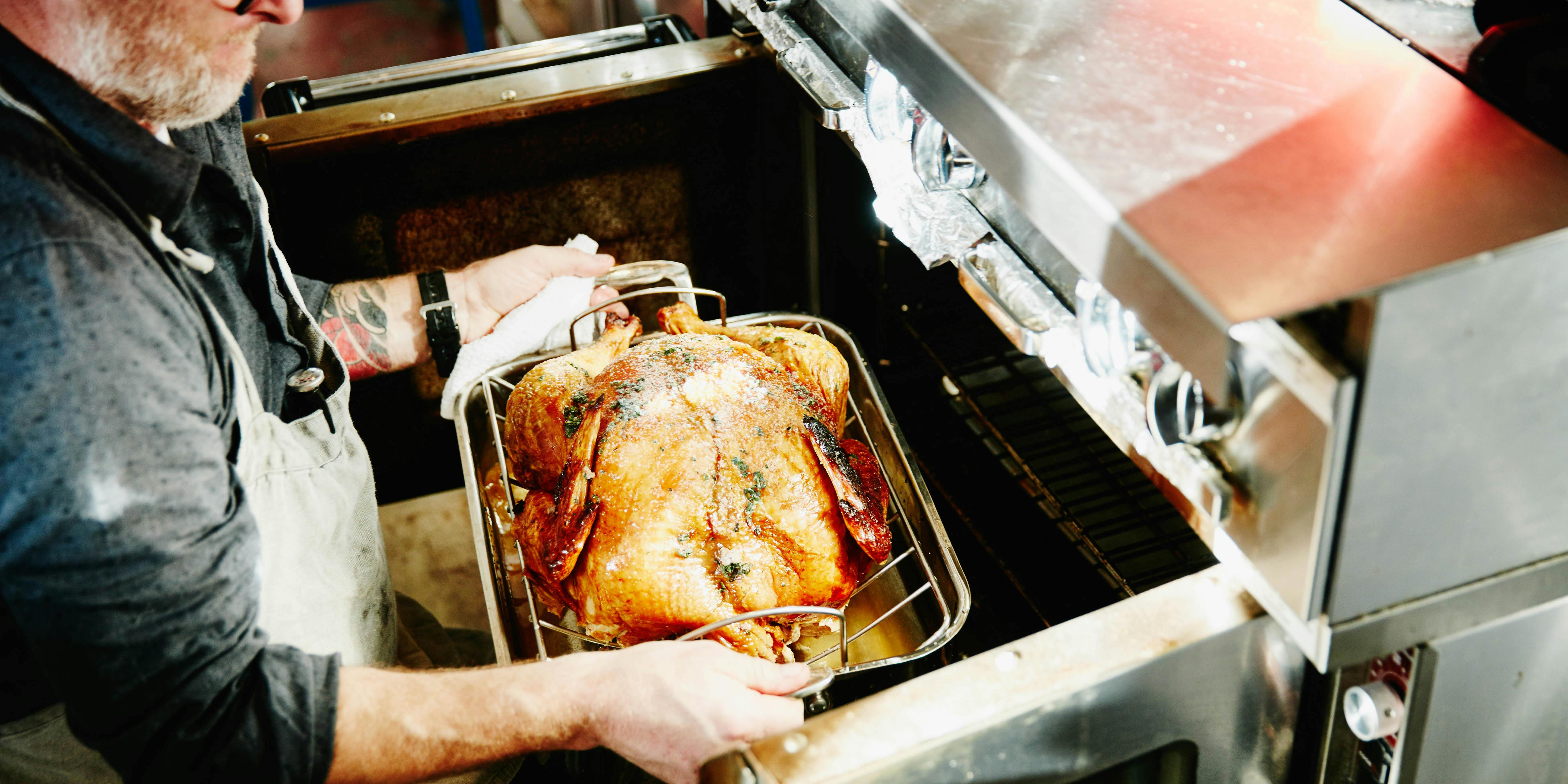 Someone holds a Danksgiving turkey.