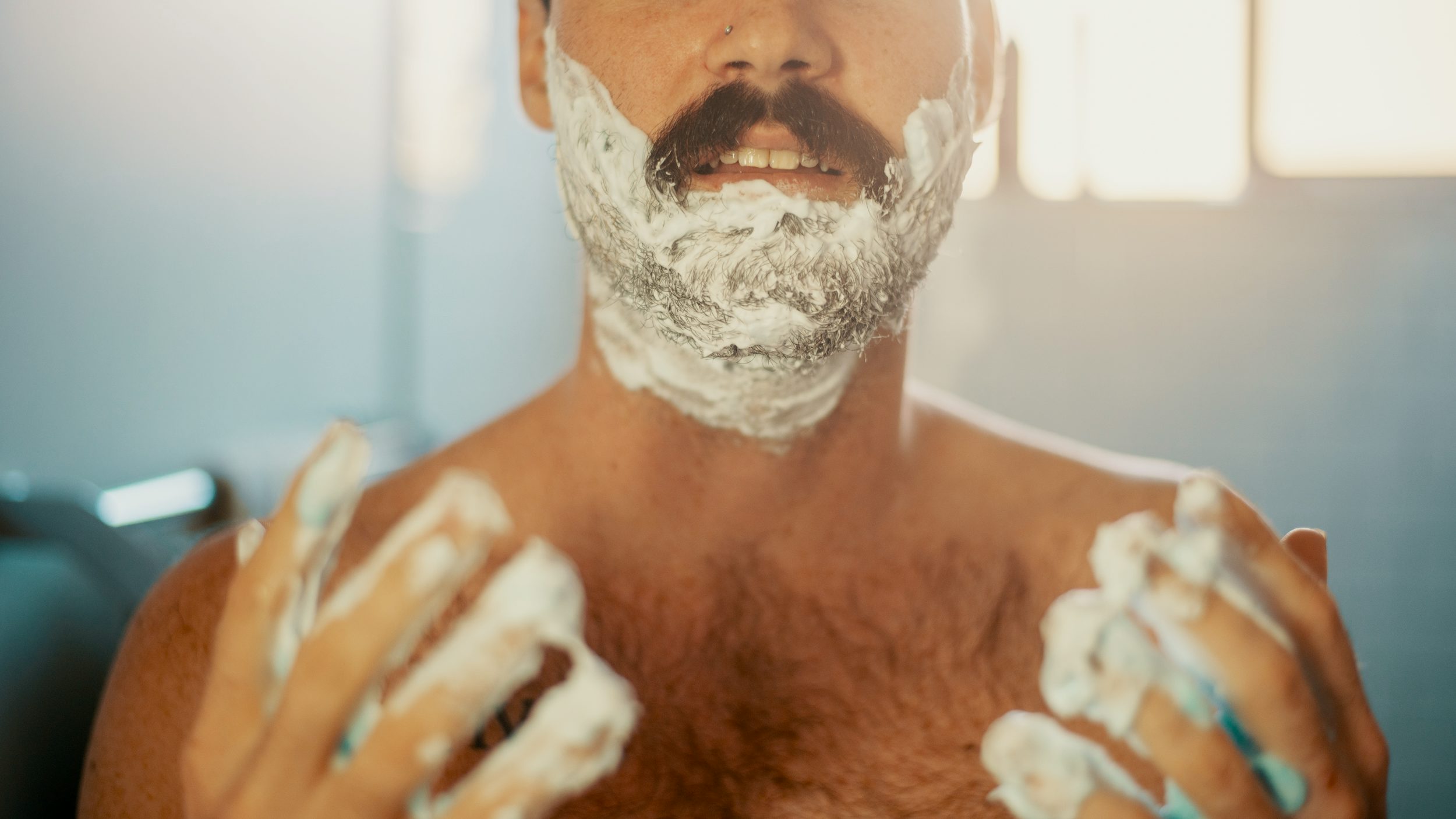 A man shaves using one of the products on the Herb holiday gift guide from Jack