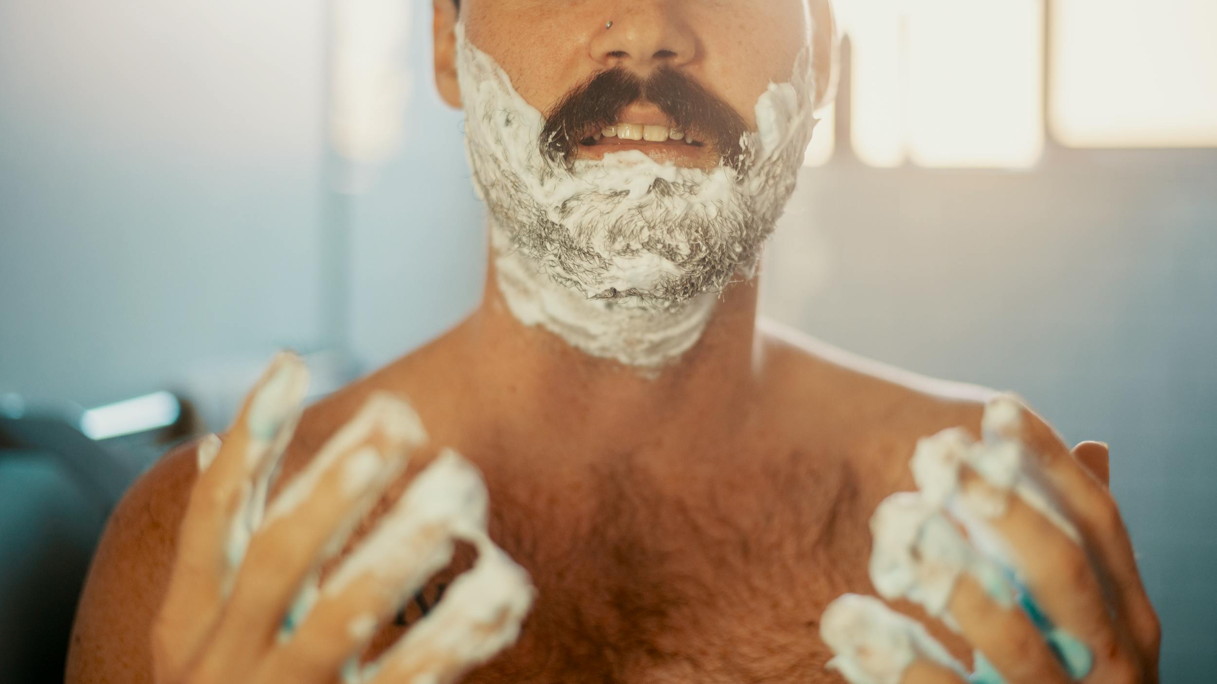 A man shaves using one of the products on the Herb holiday gift guide from Jack