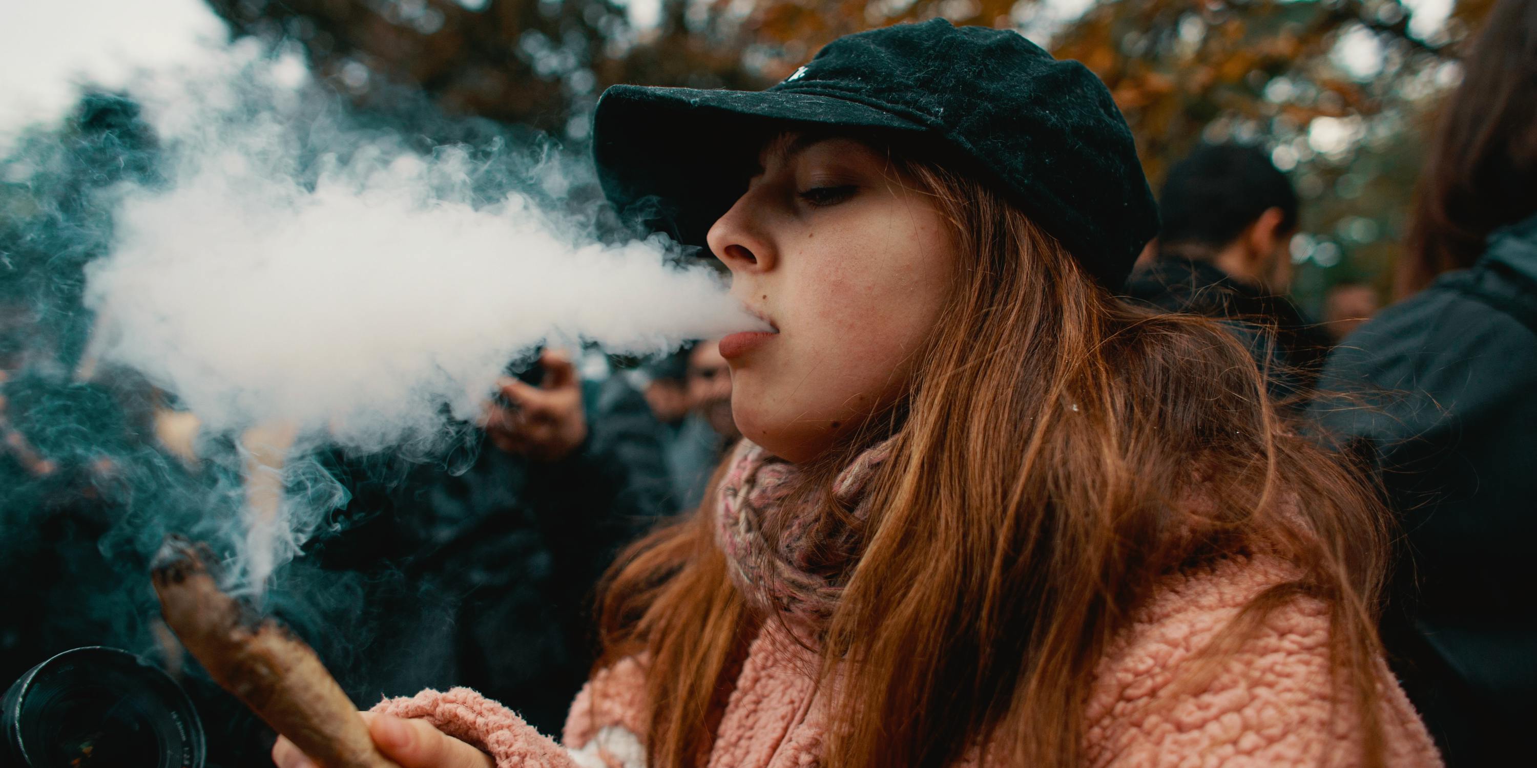A woman consumes cannabis, to find out how the recent midterms affected legal cannabis, read more here.