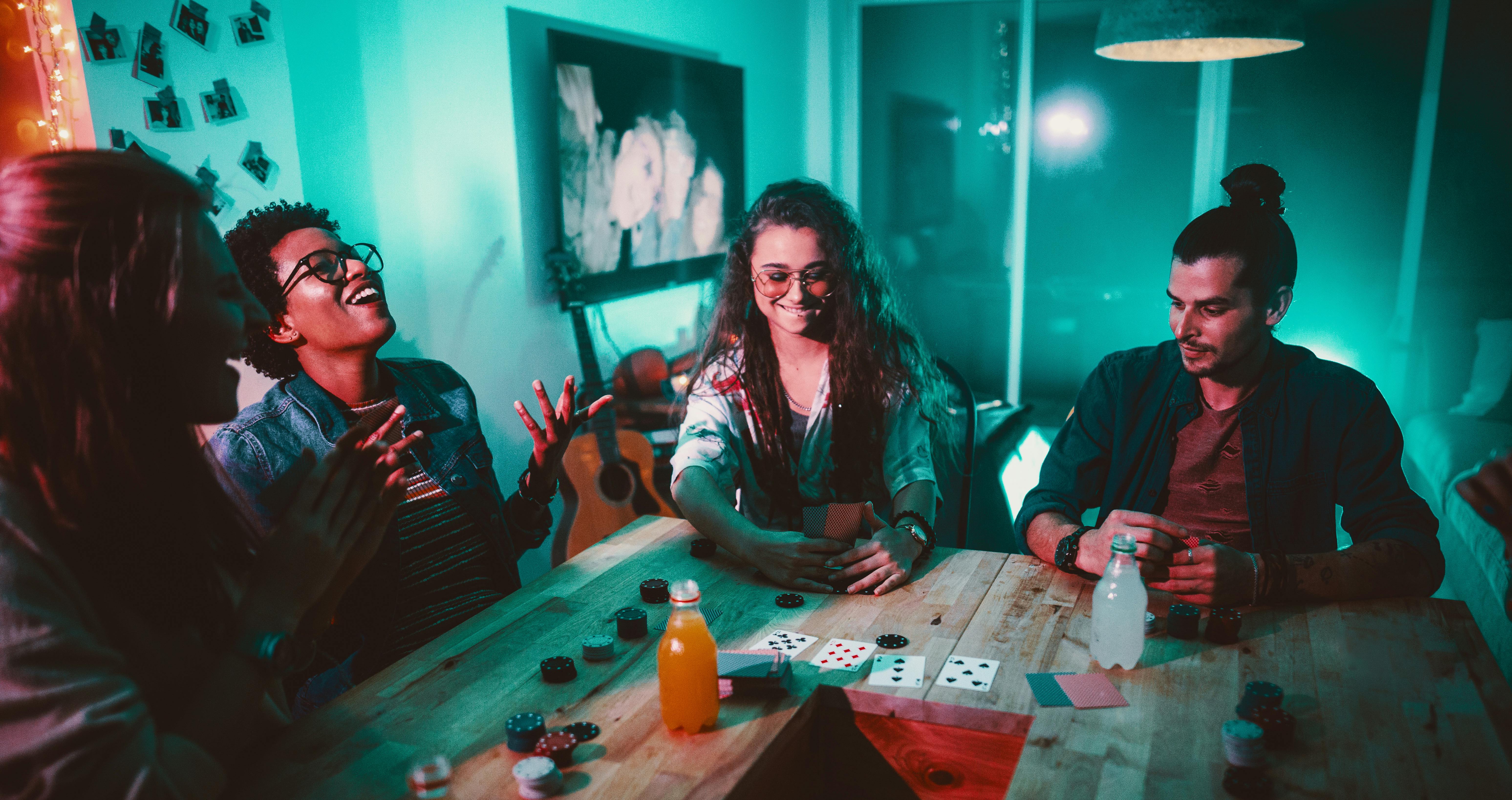 In this article, we cover all the best weed games for getting high with friends. Here, three friends are shown playing a card game