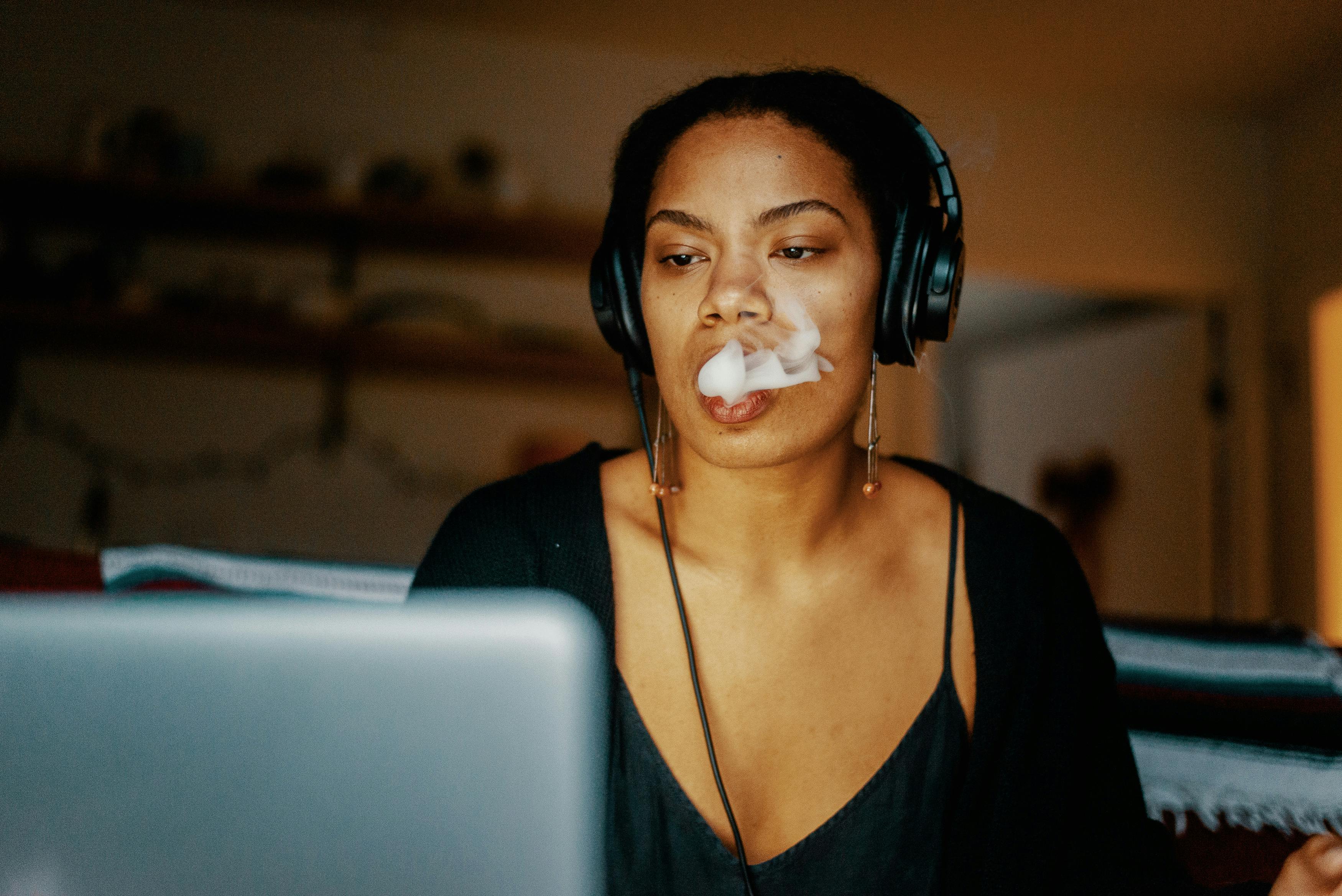 A woman watches the best weed youtube channels on her laptop