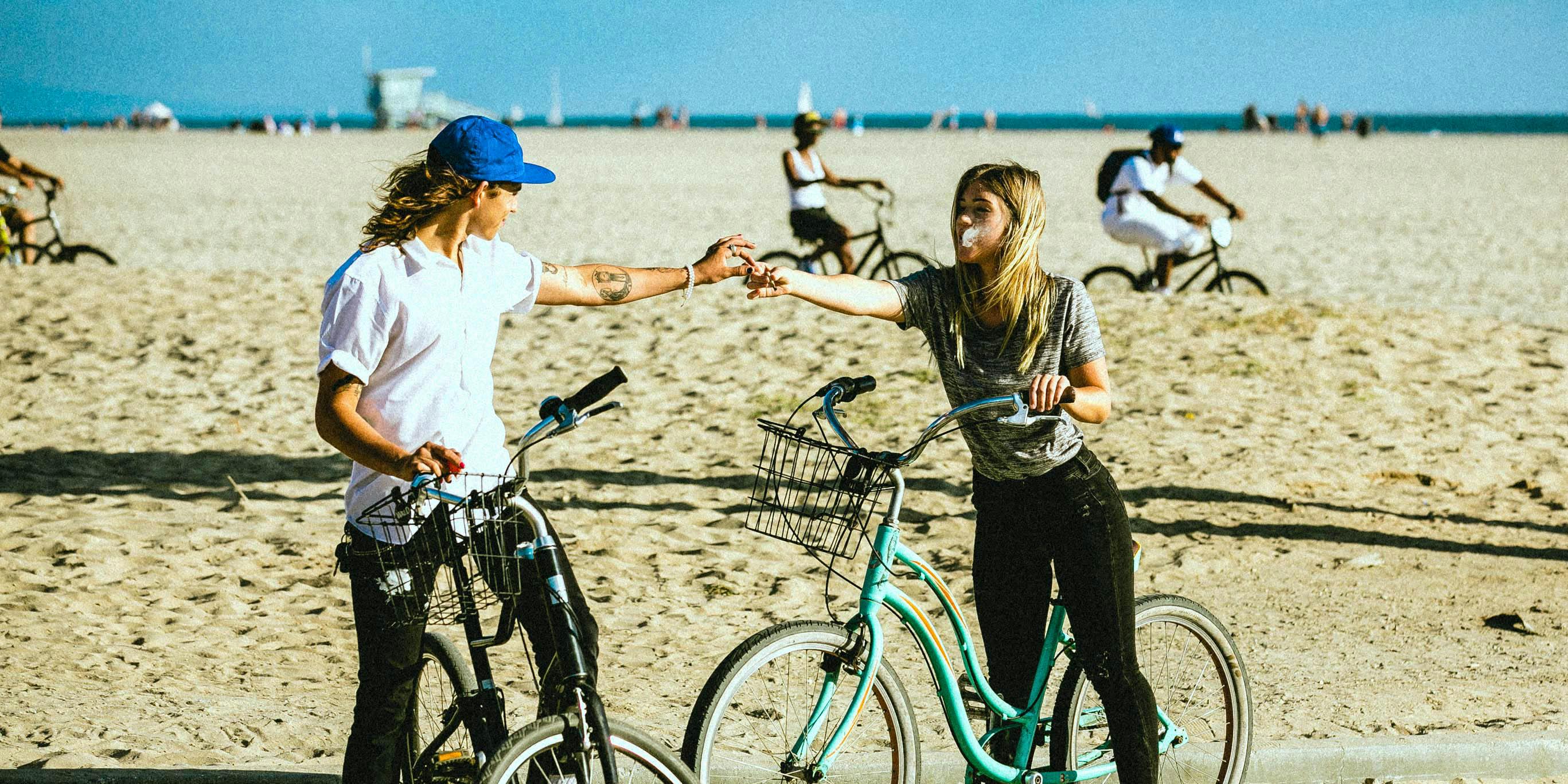 A couple share a joint on the beach. There are now more weed dating apps on the market to help people with a mutual love for the herb find their counterpart.