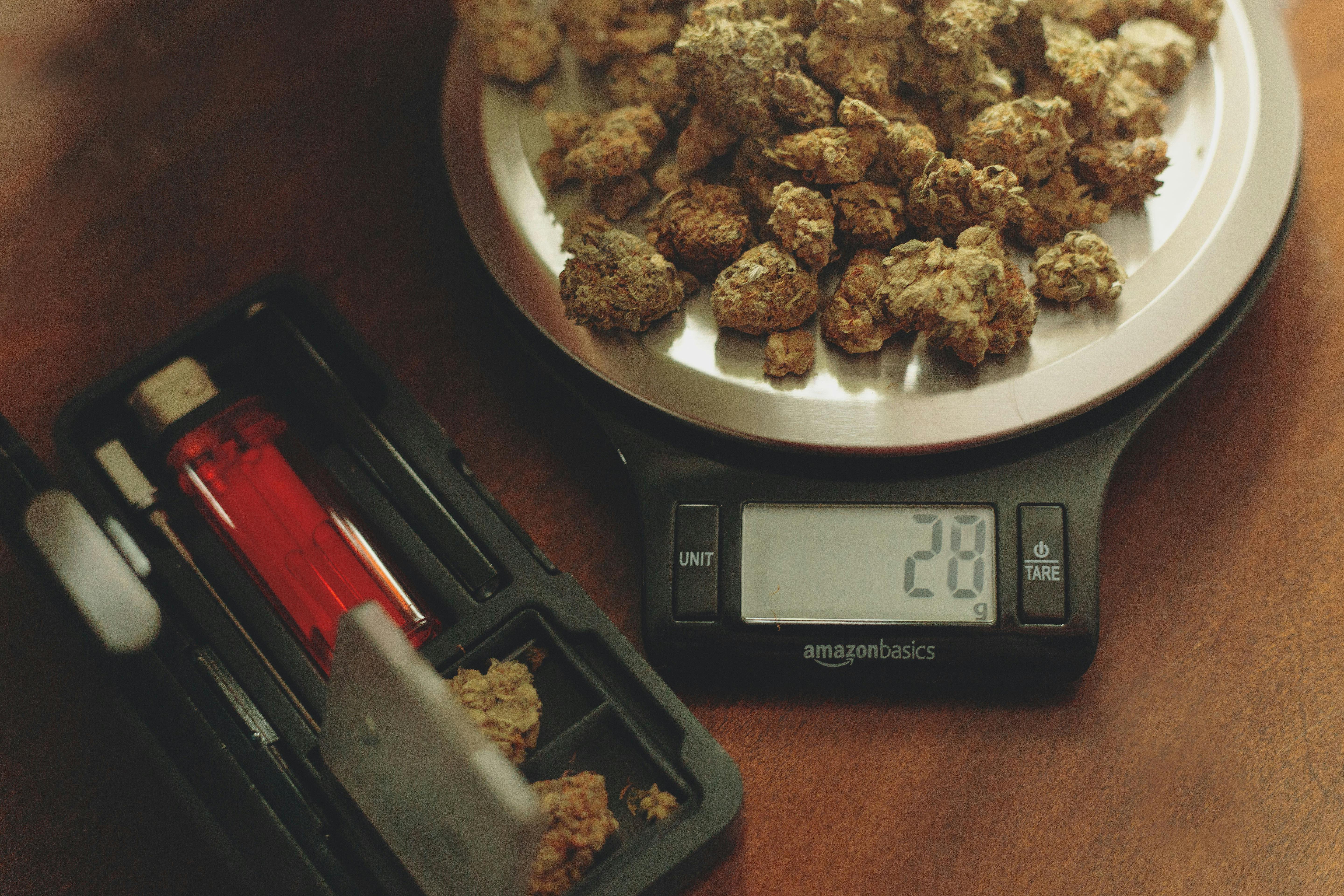 Several nugs of weed sit on a scale. Read our guide to weed weights to learn more about the common terms.