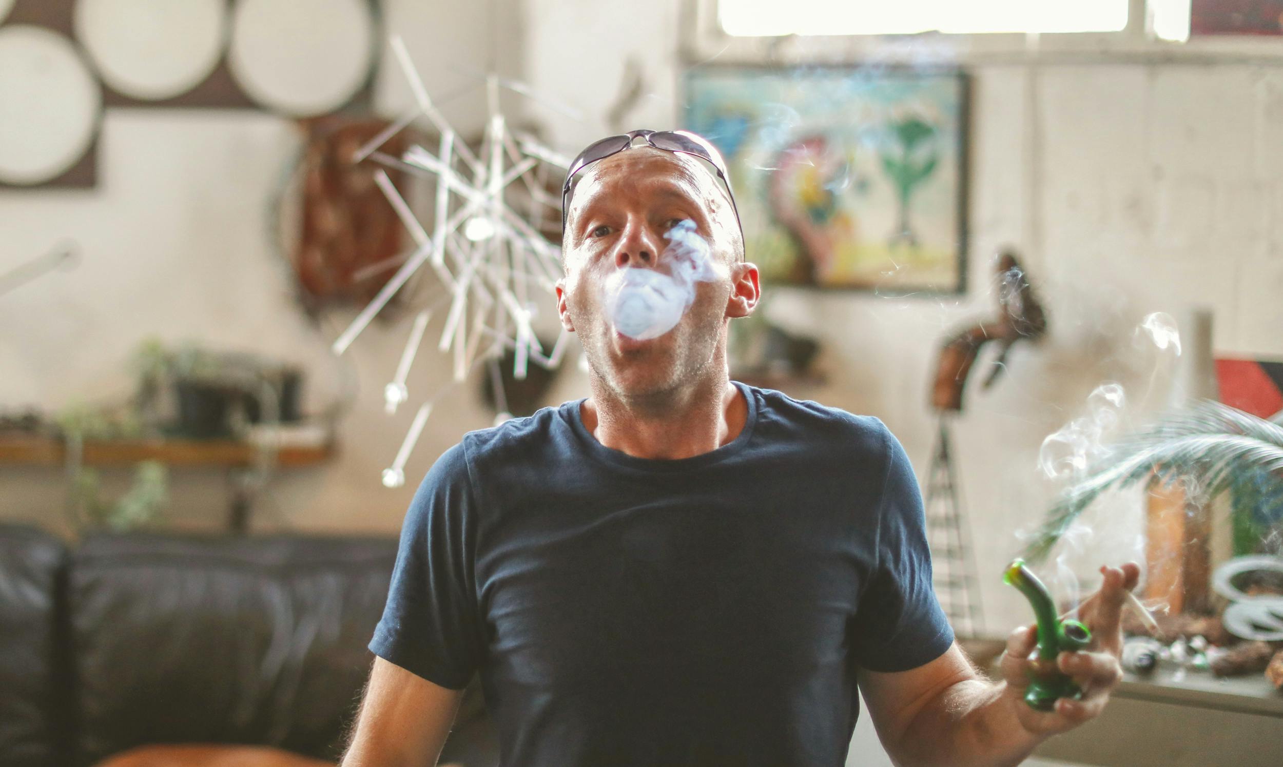 How to Make Dabs: A man exhales a massive cloud of smoke